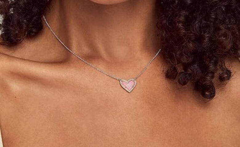 heart necklace around someone's neck