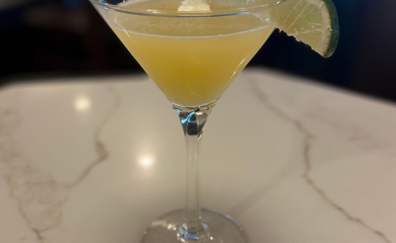 a pineapple martini on a marble countertop