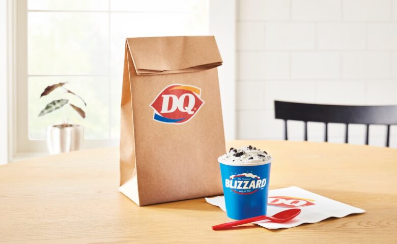 paper back with Dairy Queen on it and a Blizzard cup